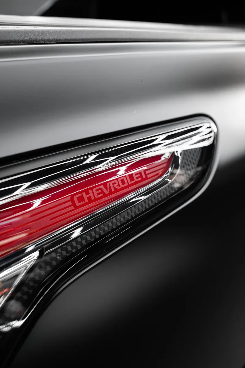 Fender marker light with Chevrolet lettering on a satin black pickup
