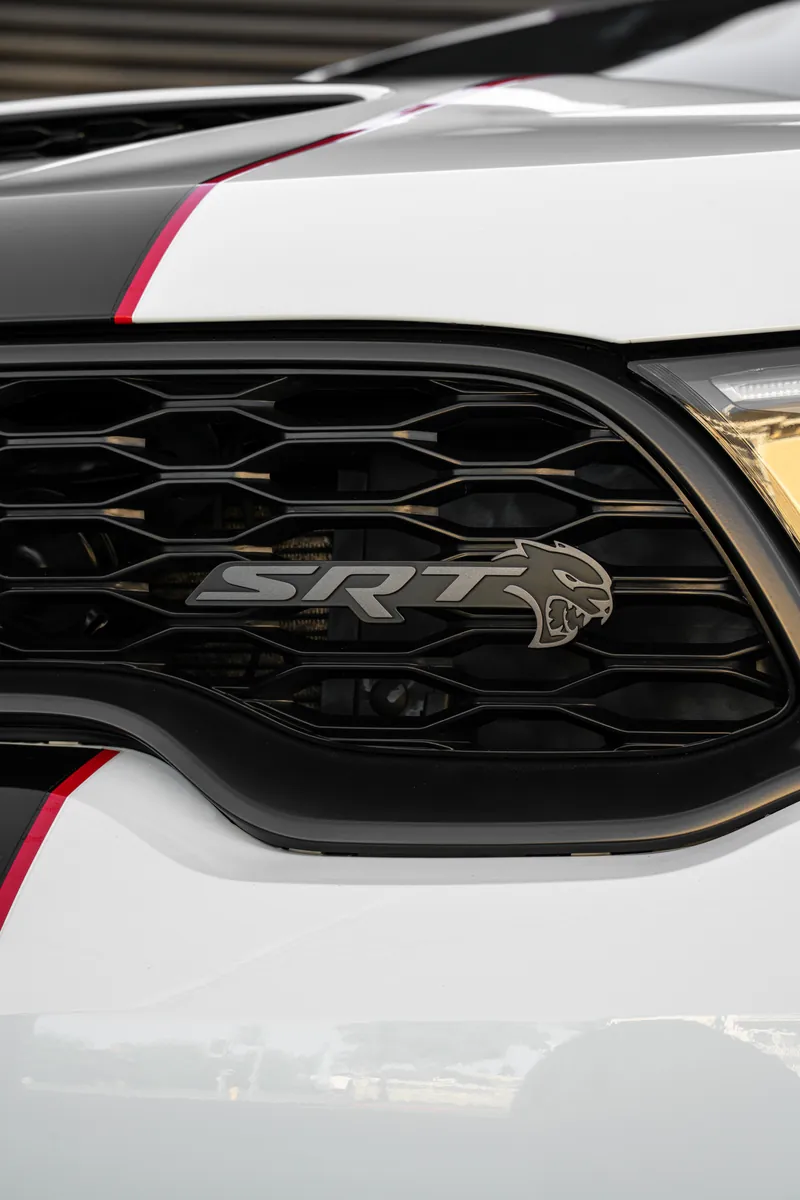SRT badge in the grille of a white Dodge Durango