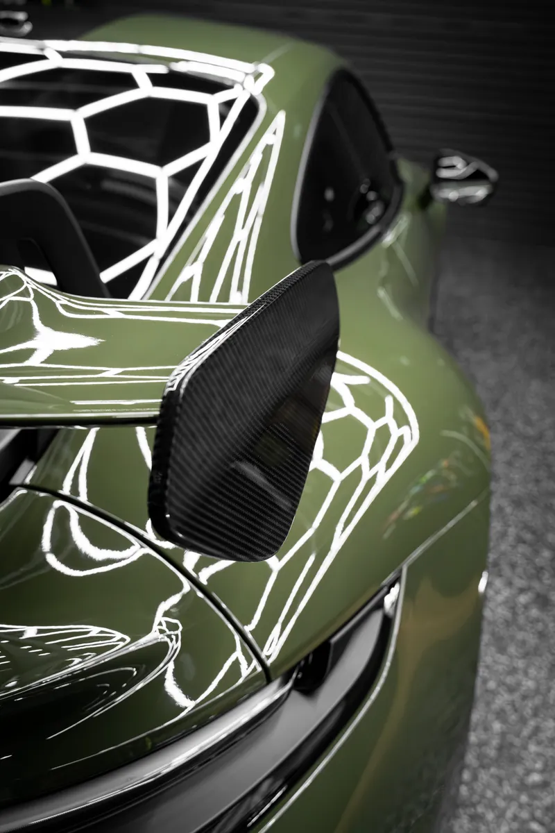 Carbon mirror and front fender on an olive green Porsche 911 GT3