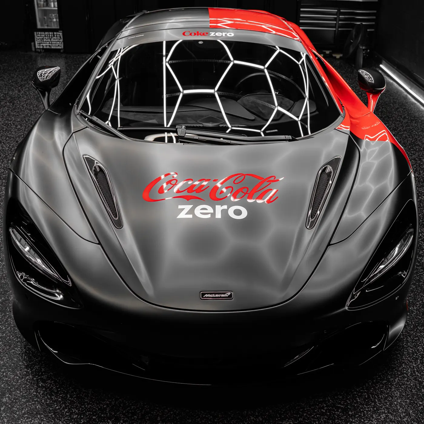 McLaren 720S in satin black with a red commercial livery